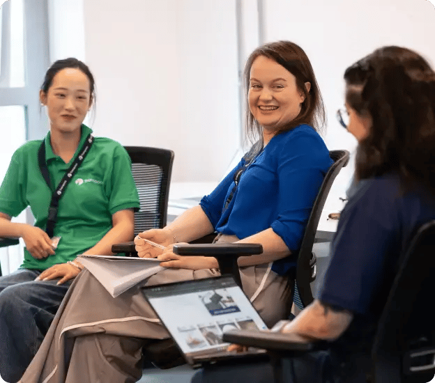 Three smiling Transpoco employees in a meeting